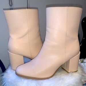 A New Day Cream color booties with sipper on the side.